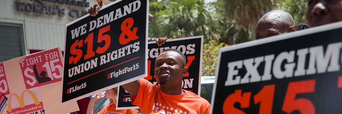 Workers rally for a $15 federal minimum wage.