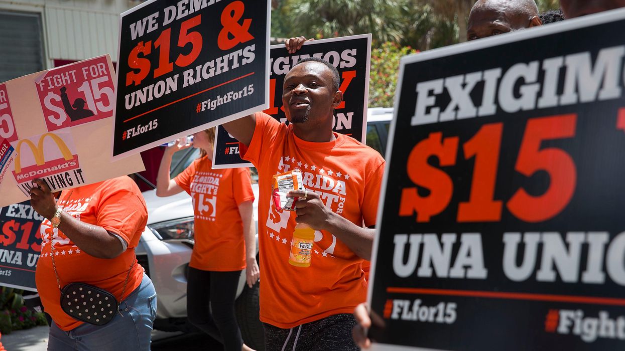 Workers rally for a $15 federal minimum wage.