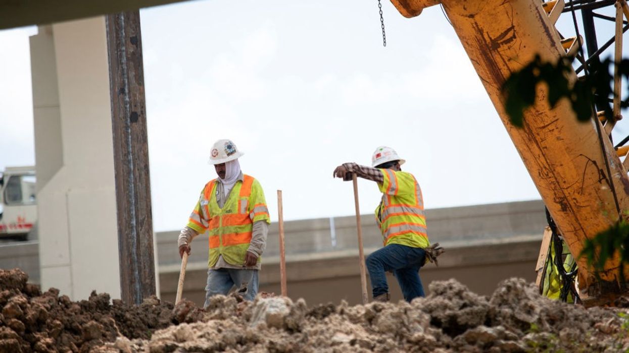 Workers rebuild a highway during a heatwave.