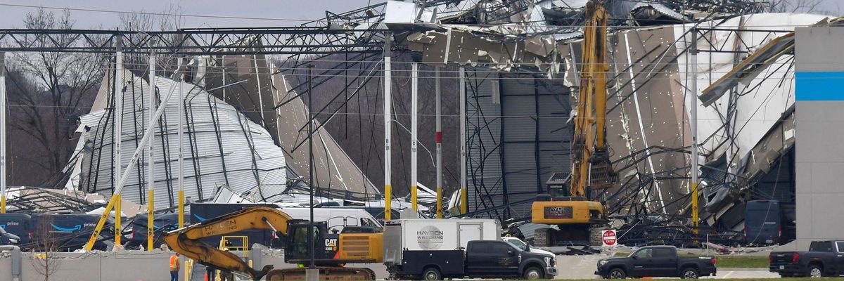 Workers remove debris from an Amazon Fulfillment Center in Edwardsville, Illinois, on December 11, 2021, after it was hit by a tornado.