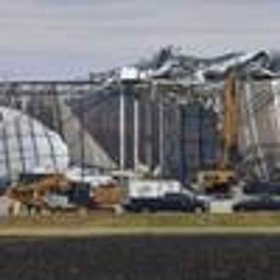 Workers remove debris from an Amazon Fulfillment Center in Edwardsville, Illinois, on December 11, 2021, after it was hit by a tornado.