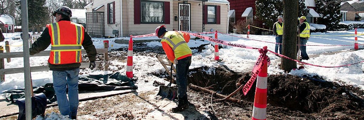 workers replace a lead pipe