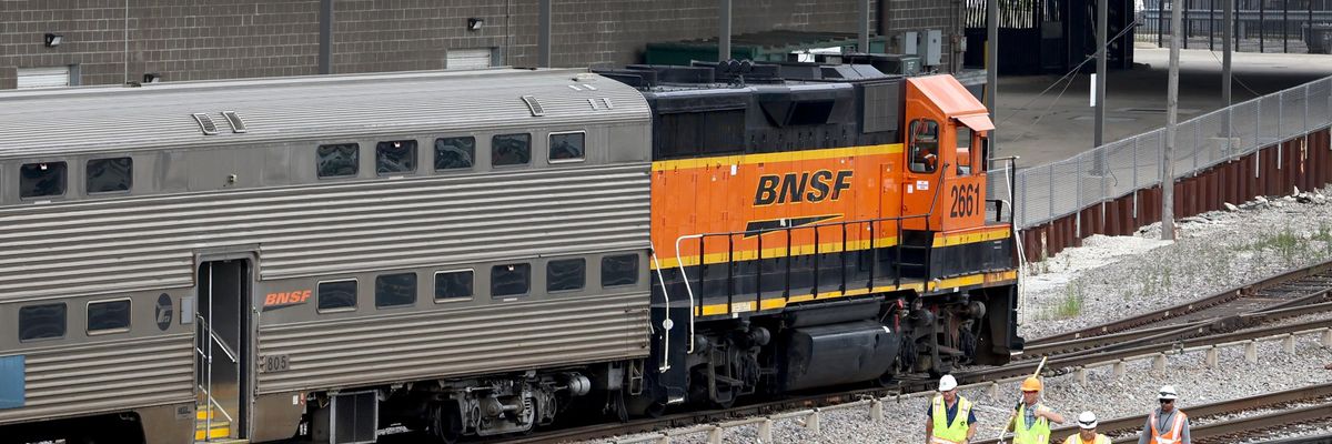 Workers service the tracks at the Metra/BNSF railroad yard