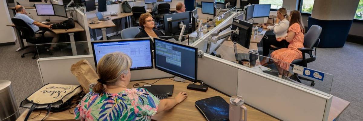 Workers sit at desks in an office in Wellesley, Massachusetts