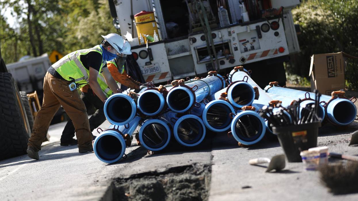 workers stack water pipes