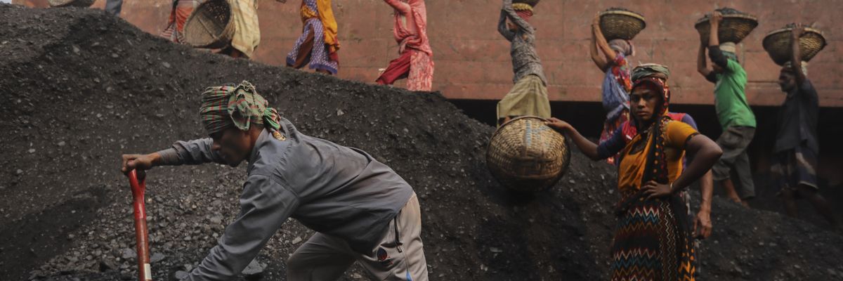 Workers unload coal from a cargo ship in Gabtoli, Bangladesh on January 9, 2021. Workers unload coal from a cargo ship in Gabtoli, Bangladesh on January 9, 2021.