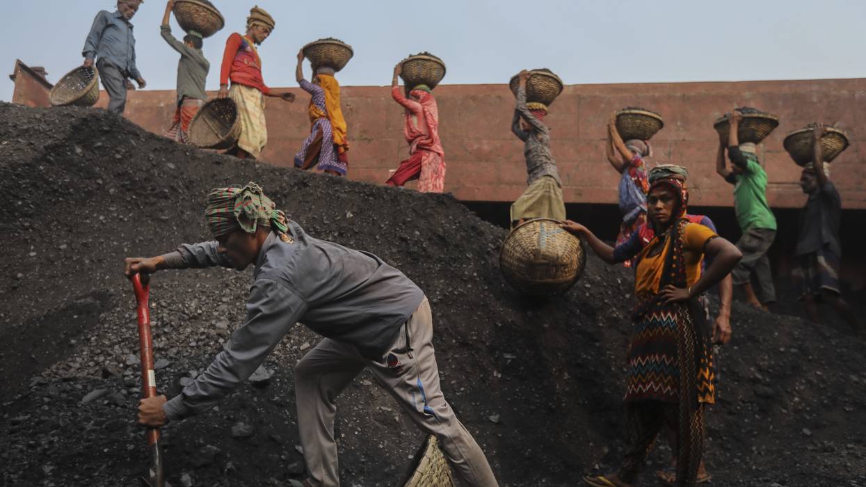 Workers unload coal from a cargo ship in Gabtoli, Bangladesh on January 9, 2021. Workers unload coal from a cargo ship in Gabtoli, Bangladesh on January 9, 2021.