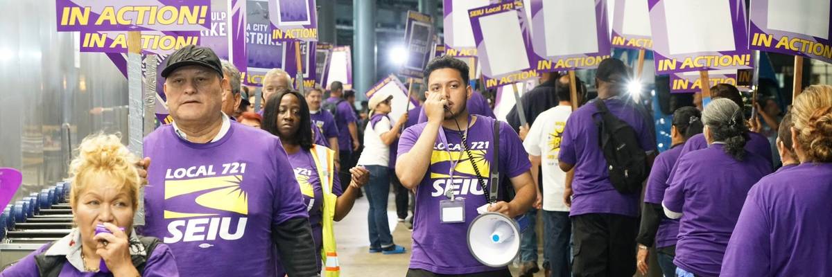 Workers walk a picket line at Los Angeles International Airport