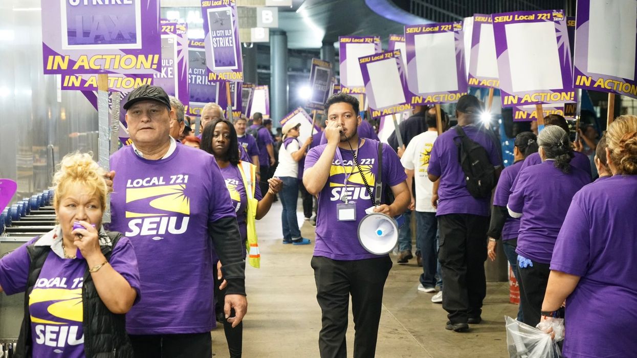 Workers walk a picket line at Los Angeles International Airport