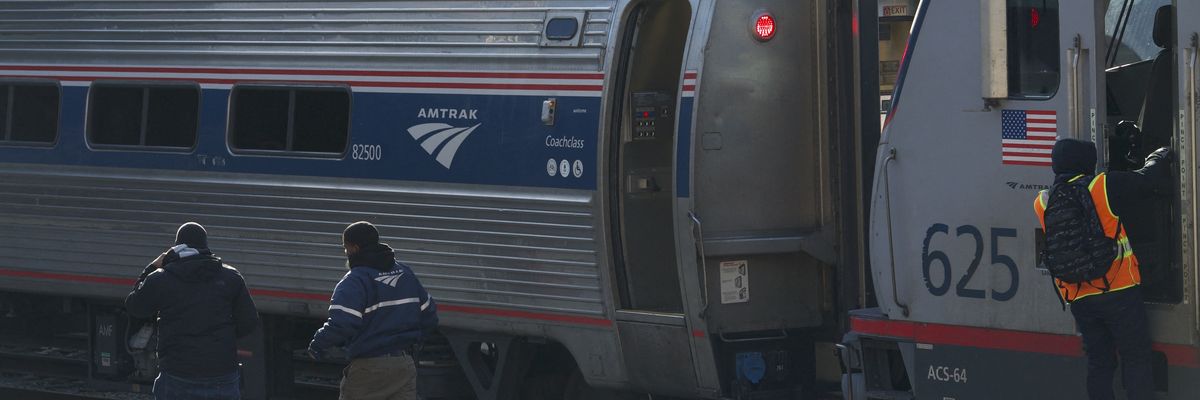 Workers walk on a platform at Union Station