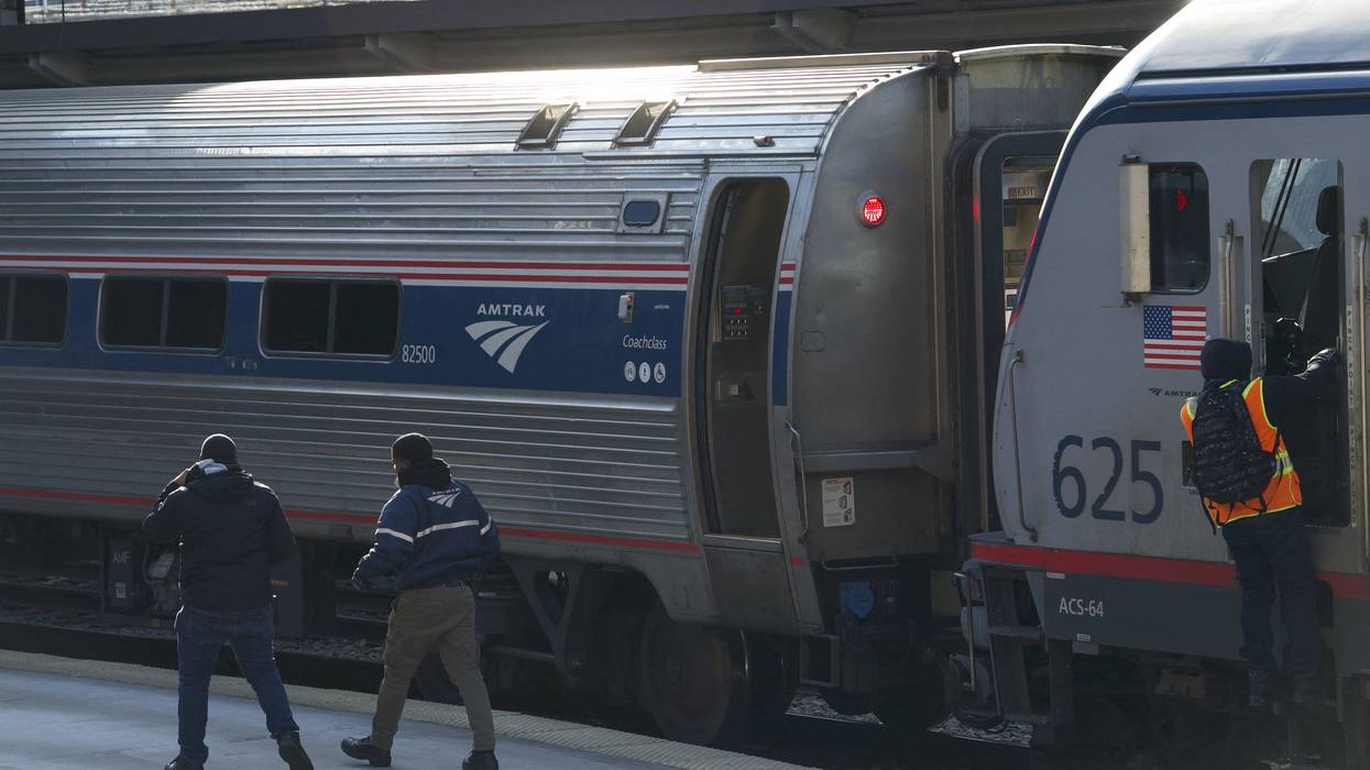 Workers walk on a platform at Union Station
