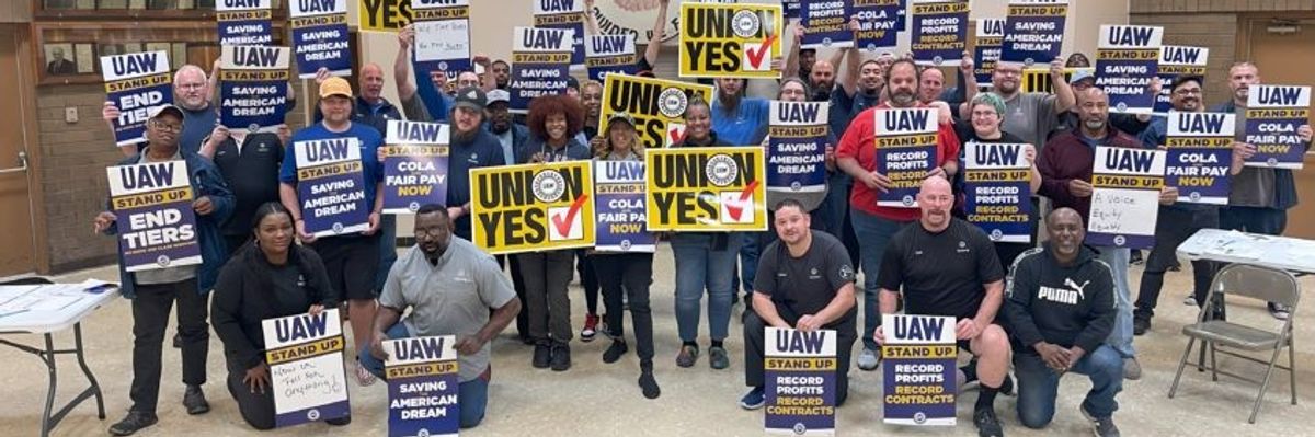 Workers with UAW signs.