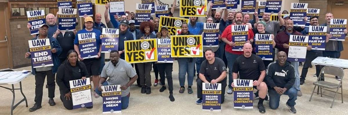 Workers with UAW signs.