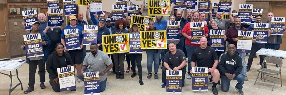 Workers with UAW signs.