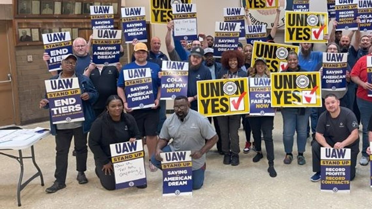 Workers with UAW signs.