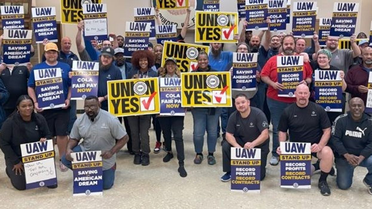 Workers with UAW signs.