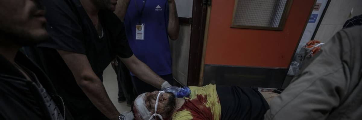 Wounded man in Gaza by Israeli bombing