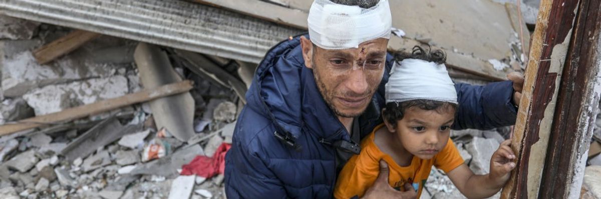 Wounded Palestinians amid the rubble of destroyed homes in Rafah
