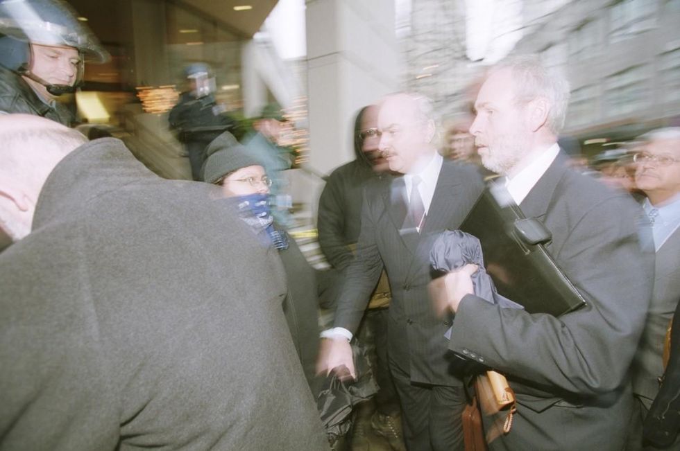 WTO delegates attempt to rush through blockade. Photo: (C) 1999 Dang Ngo_ZUMA Press.