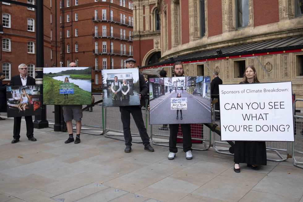 XR protest with photos of UK flooding.
