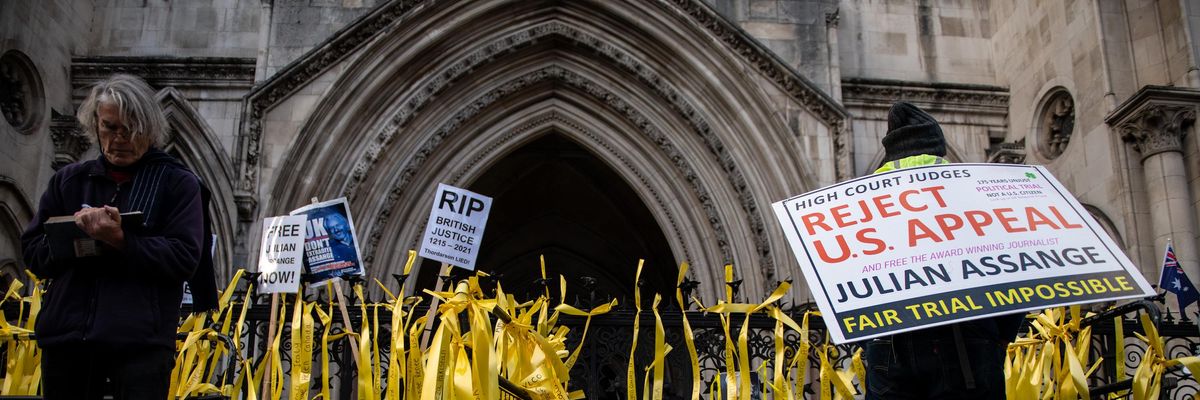 Yellow ribbons with messages from supporters of Julian Assange are tied to the railings of the Royal Courts of Justice during an appeal hearing for his extradition to the United States on October 27, 2021 in London