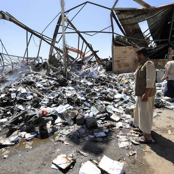 Yemeni men assess damage from Saudi strike