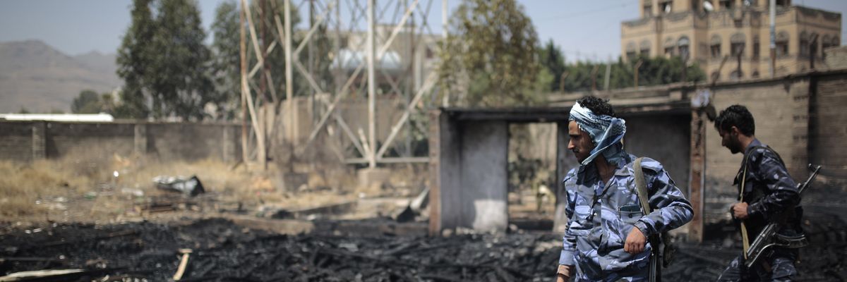 Yemeni policemen inspect a site that was damaged by an air strike allegedly carried out by the Saudi-led coalition.