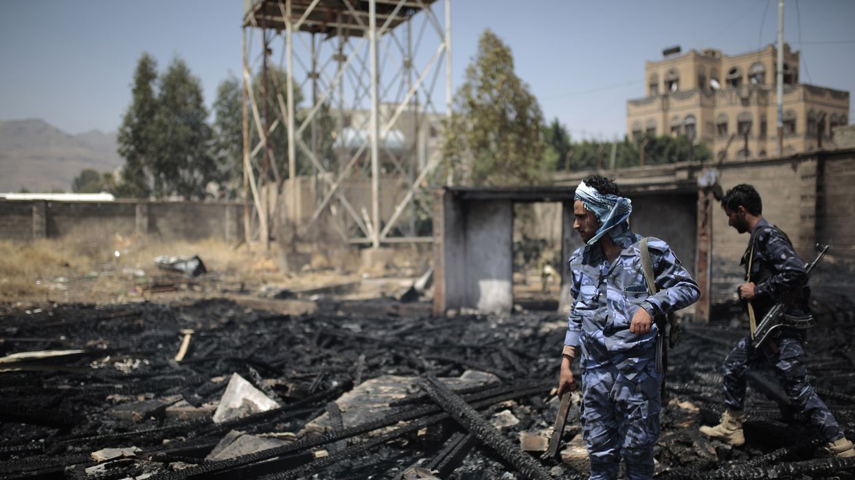 Yemeni policemen inspect a site that was damaged by an air strike allegedly carried out by the Saudi-led coalition.