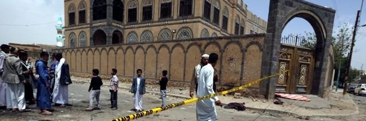 Yemenis and members of the Houthi militia inspect the scene of a suicide attack a day after it targeted a Houthi mosque in Sanaa