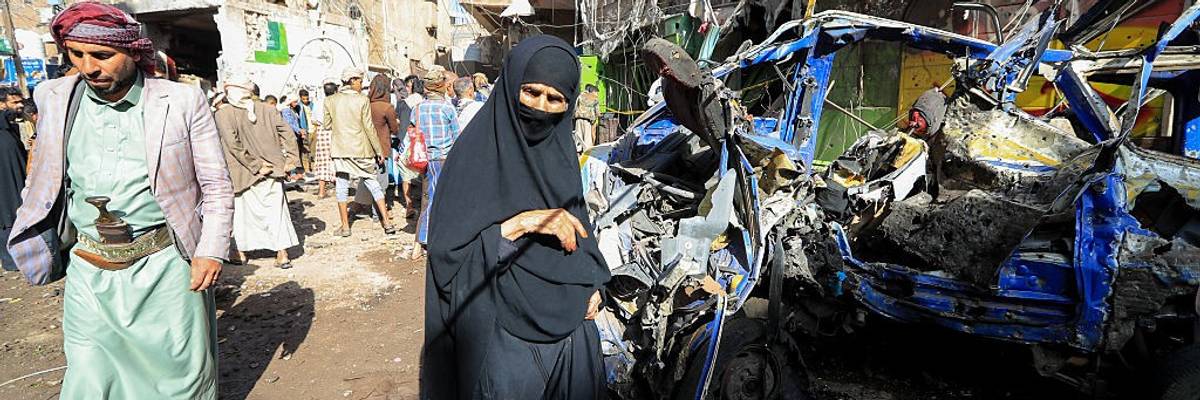 Yemenis inspect damage caused by a US airstrike on a market in Sanaa
