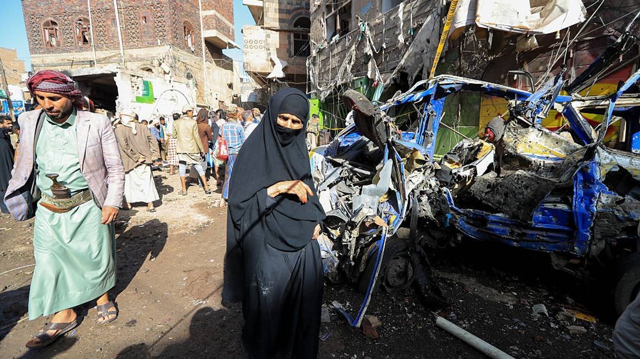 Yemenis inspect damage caused by a US airstrike on a market in Sanaa