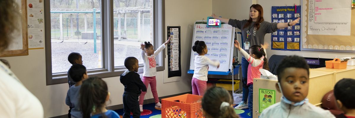 Young children participate in morning warm-up in a Head Start classroom