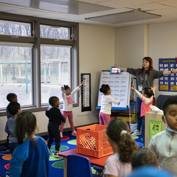 Young children participate in morning warm-up in a Head Start classroom