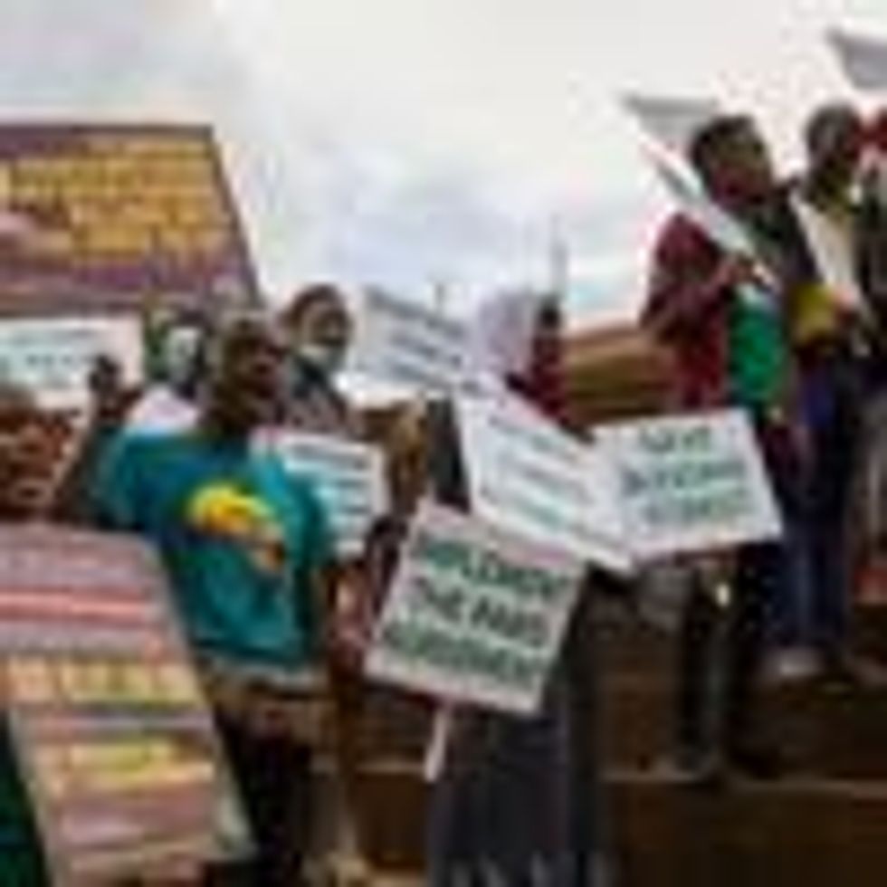 Young environment activists hold placards with climate change-related messages directed toward the Ugandan government and other world leaders at Kampala International University as part of the Fridays for Future global climate strike under the motto