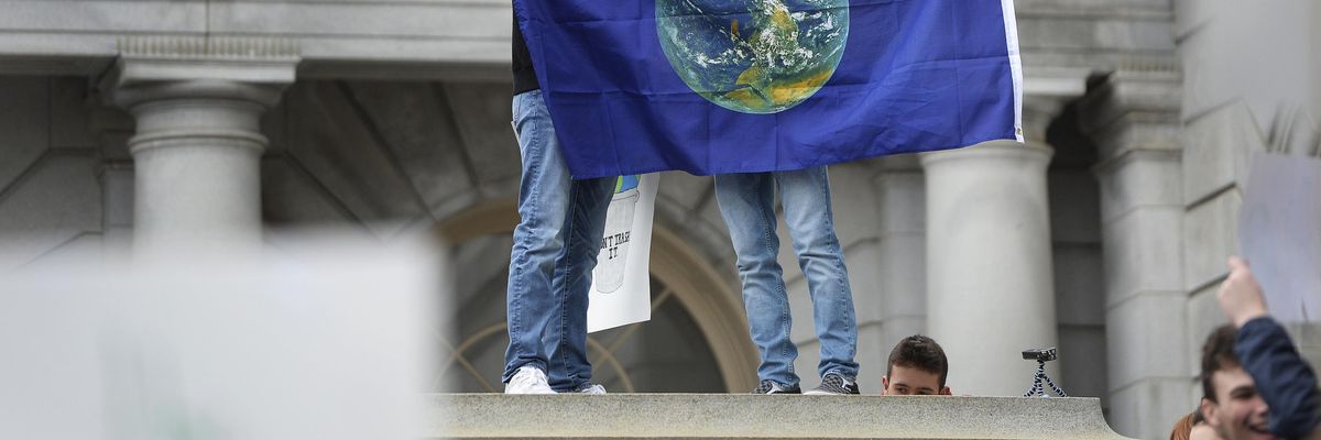 Youth hold Earth flag