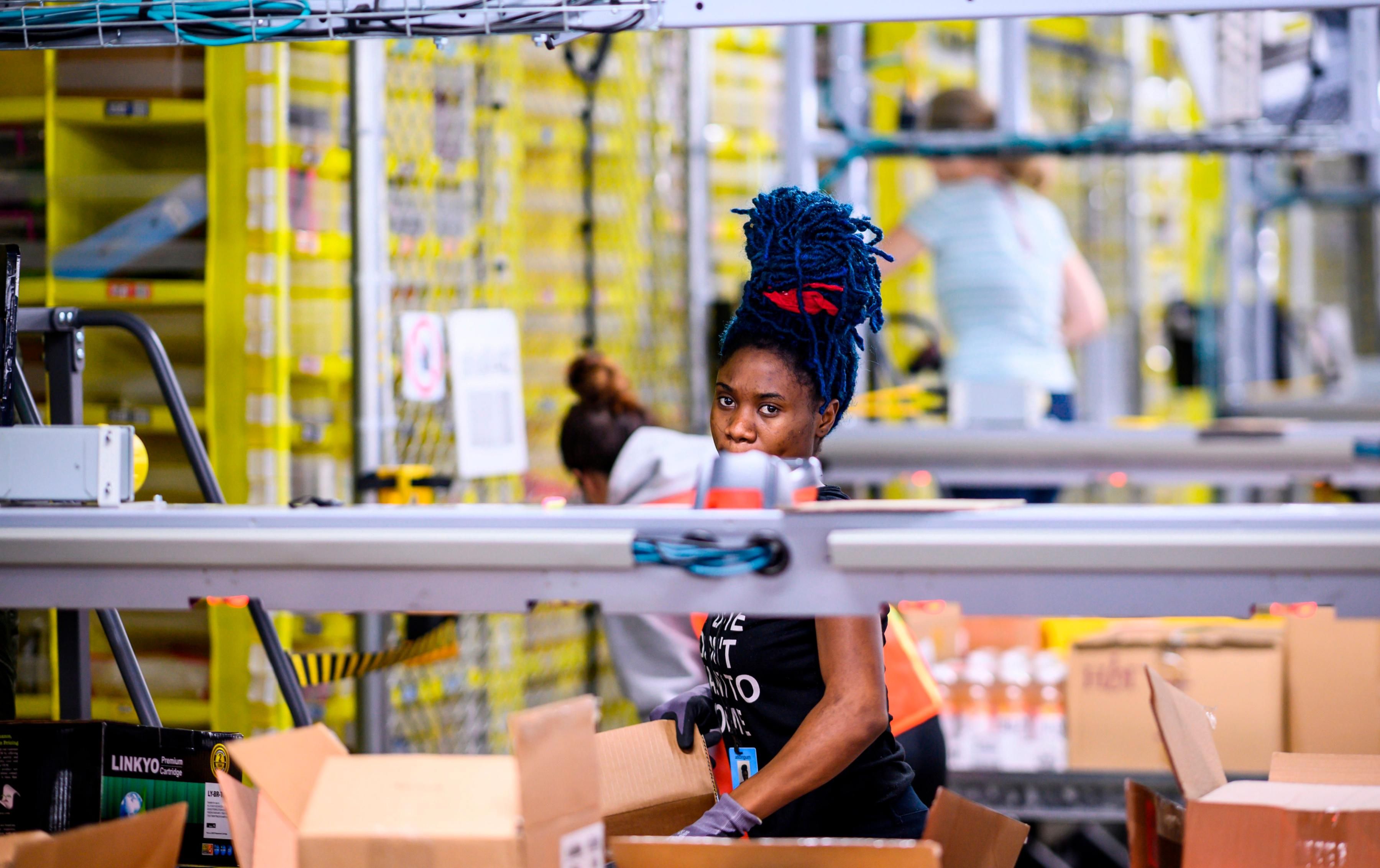 Amazon workers at a distribution station