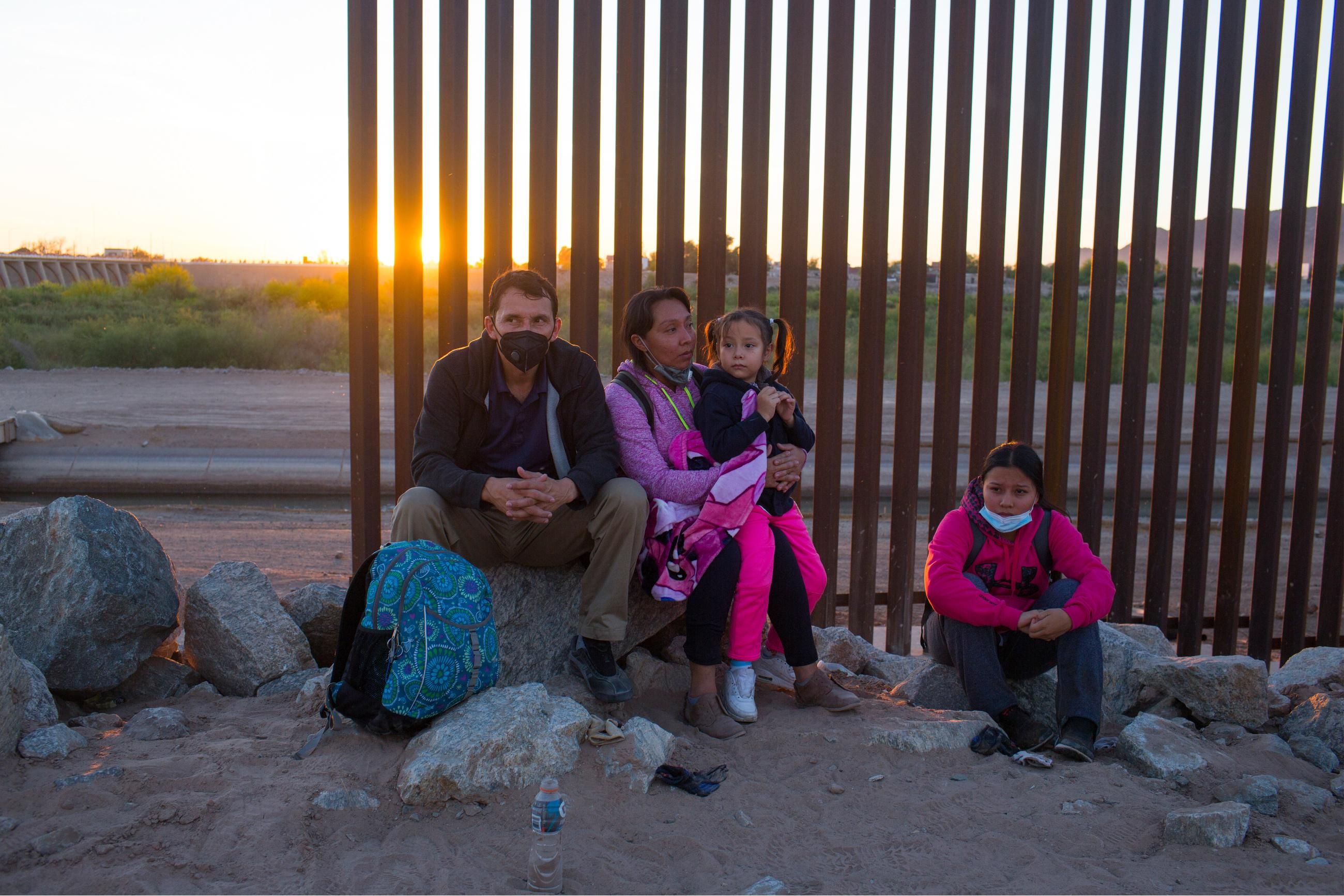 A migrant family from Central America waits to be processed by the U.S. Border Patrol after they crossed into the United States from Mexico on April 29, 2021 near Yuma, Arizona. (Photo: Andrew Lichtenstein/Corbis via Getty Images)