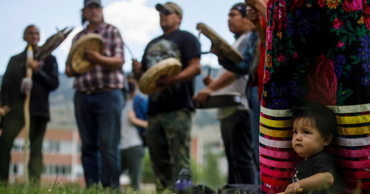 Indigenous people gather at the site of Kamloops Indian Residential School.