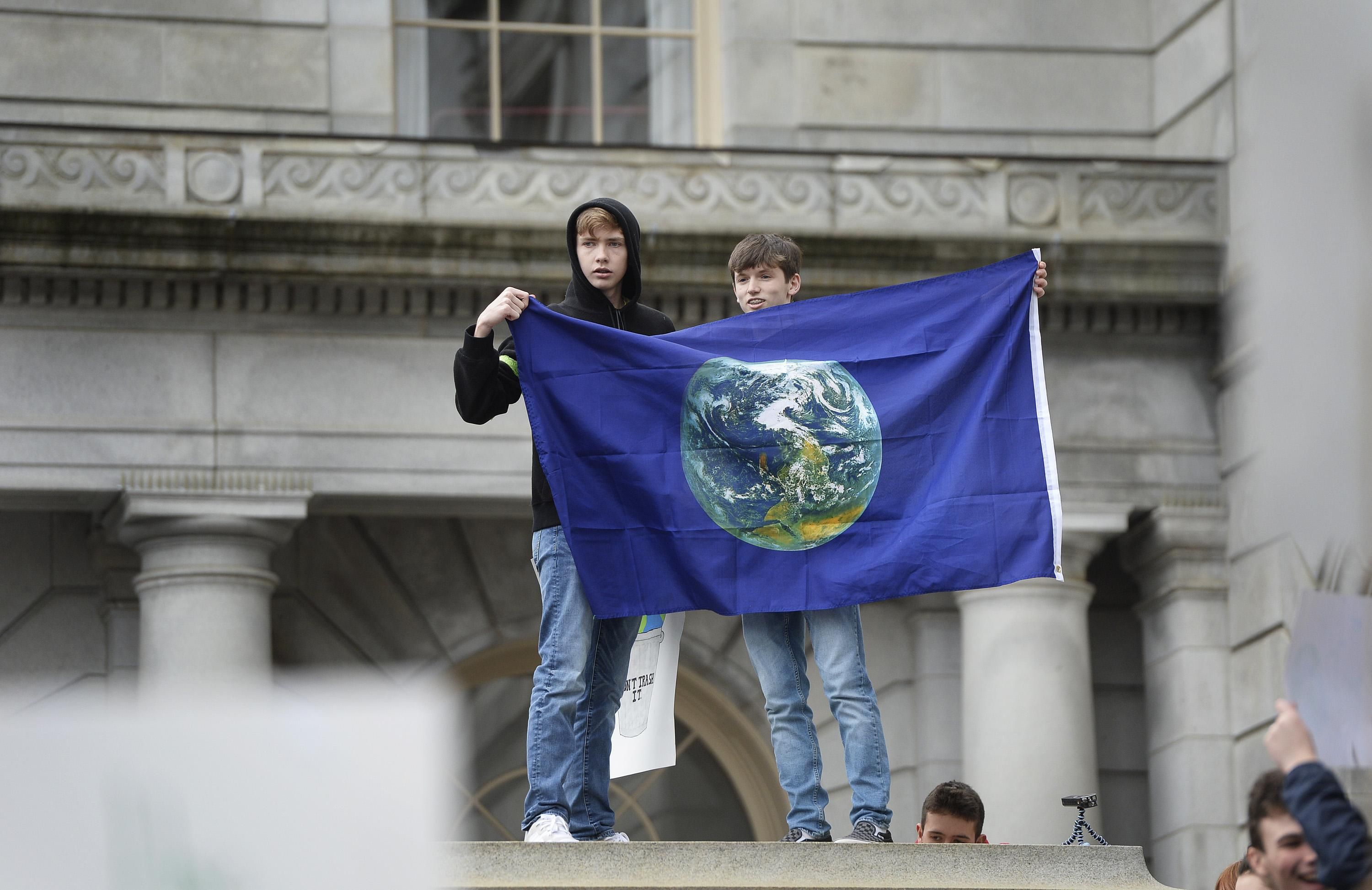 Youth hold Earth flag