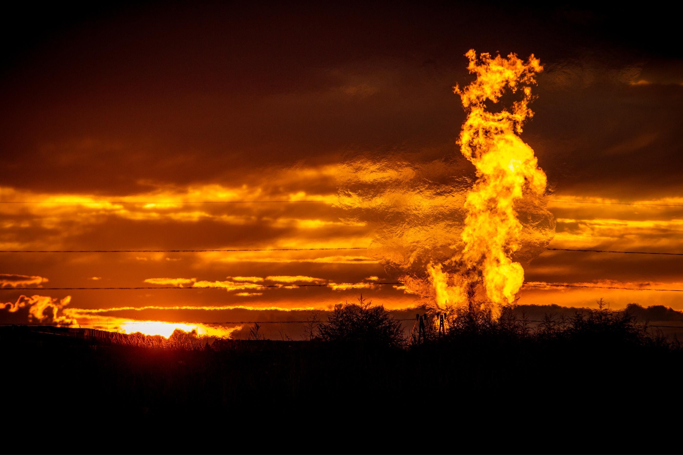 Flames rise from a flaring pit near a well in the Bakken Oil Field. The primary component of natural gas is methane, which is odorless when it comes directly out of the gas well. (Photo: Orjan F. Ellingvag/Corbis via Getty Images)