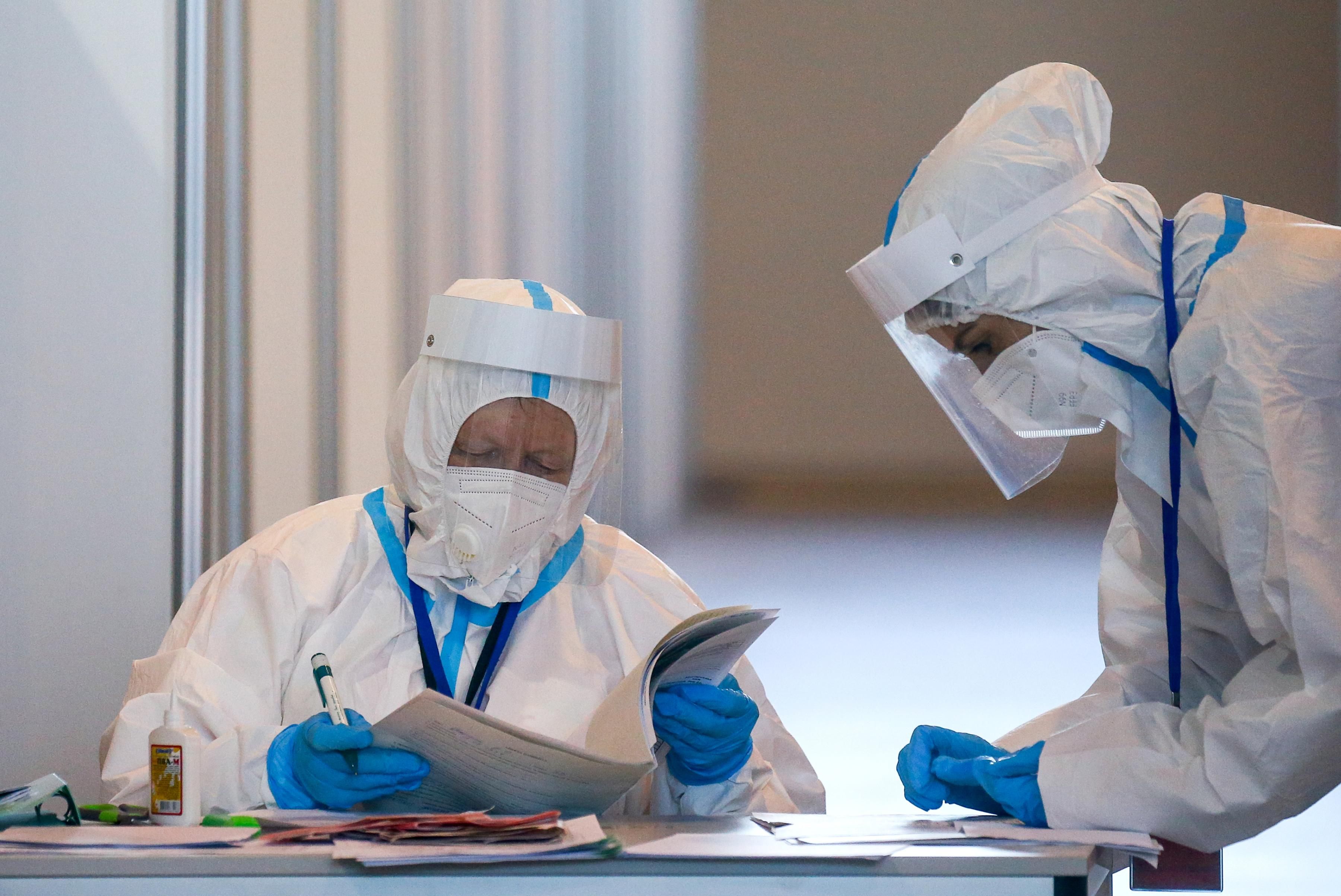 Medical workers examine paperwork