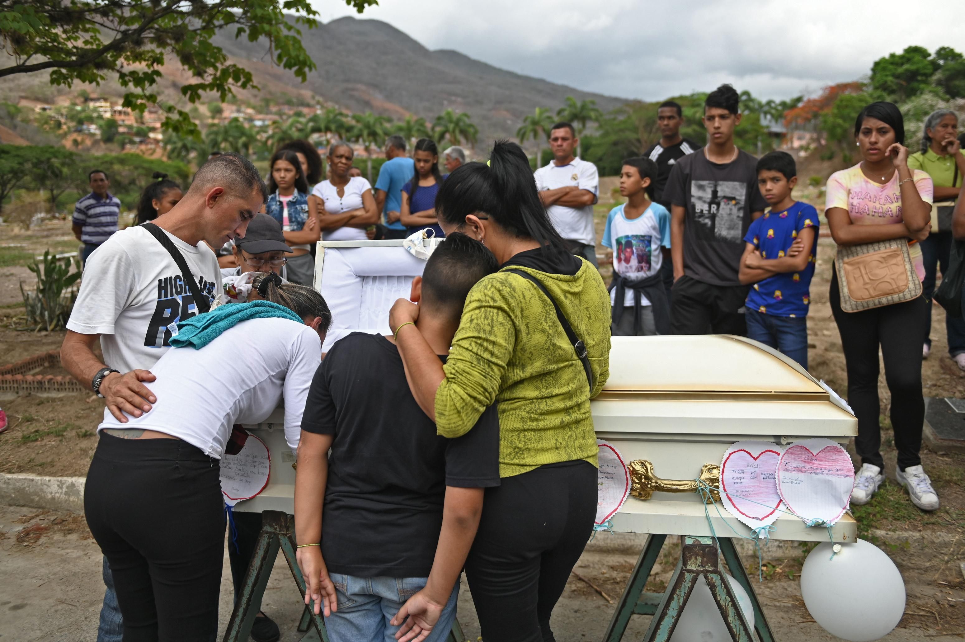 Relatives and friends of 11-year-old Erick Altuve, a Venezuelan boy who died of cancer while waiting to receive a bone marrow transplant, attend his funeral at a cemetery in Caracas, on May 30, 2019. (Photo: Marvin Recinos/AFP via Getty Images)