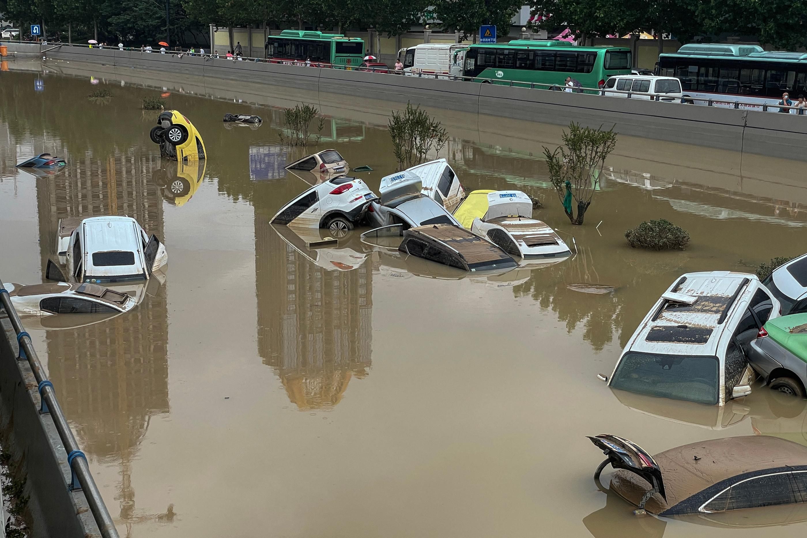 Cars sit in floodwaters after heavy rains hit the city of Zhengzhou in China's central Henan province on July 21, 2021. (Photo: STR/AFP via Getty Images)