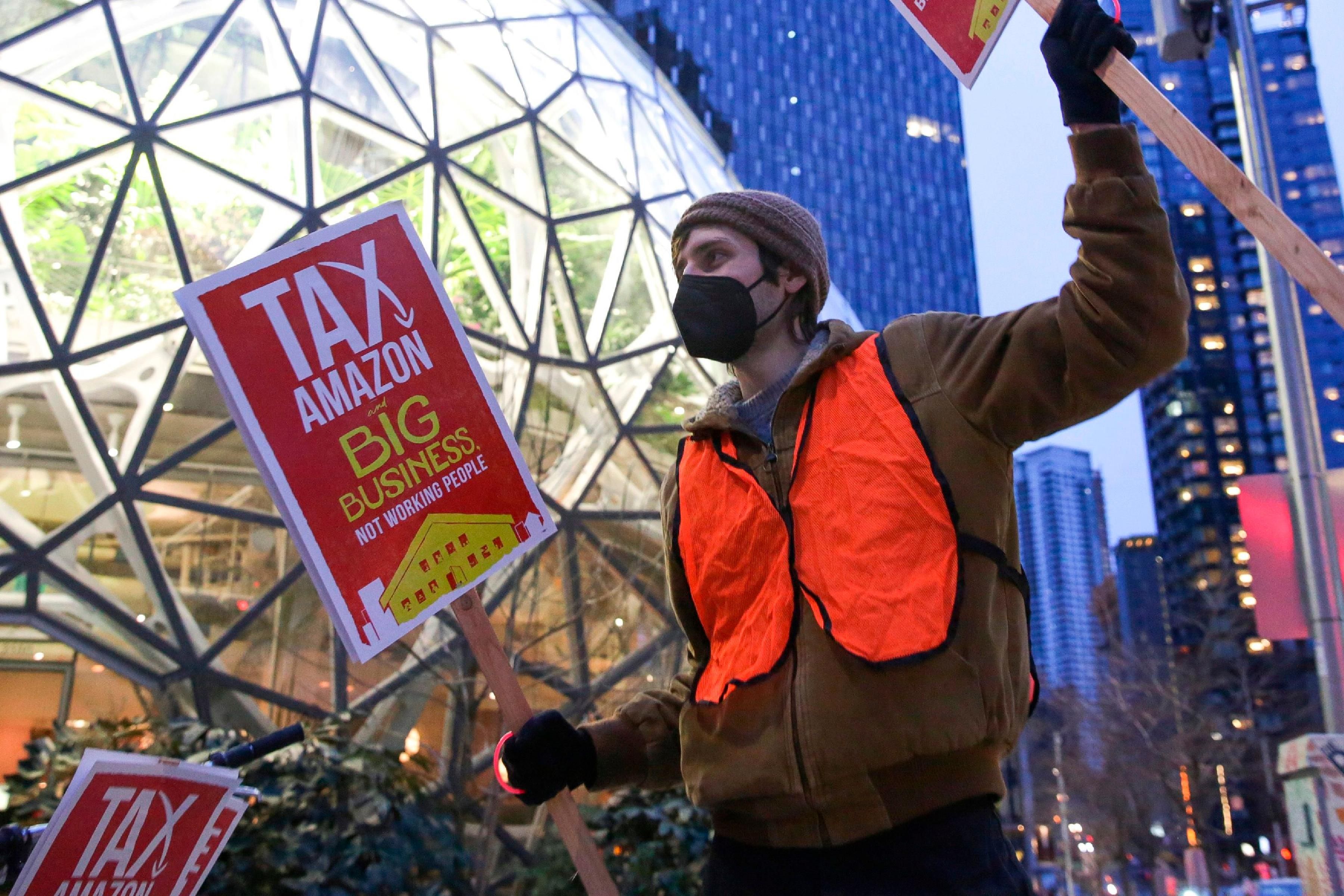 Demonstrators take part in a Tax Amazon protest