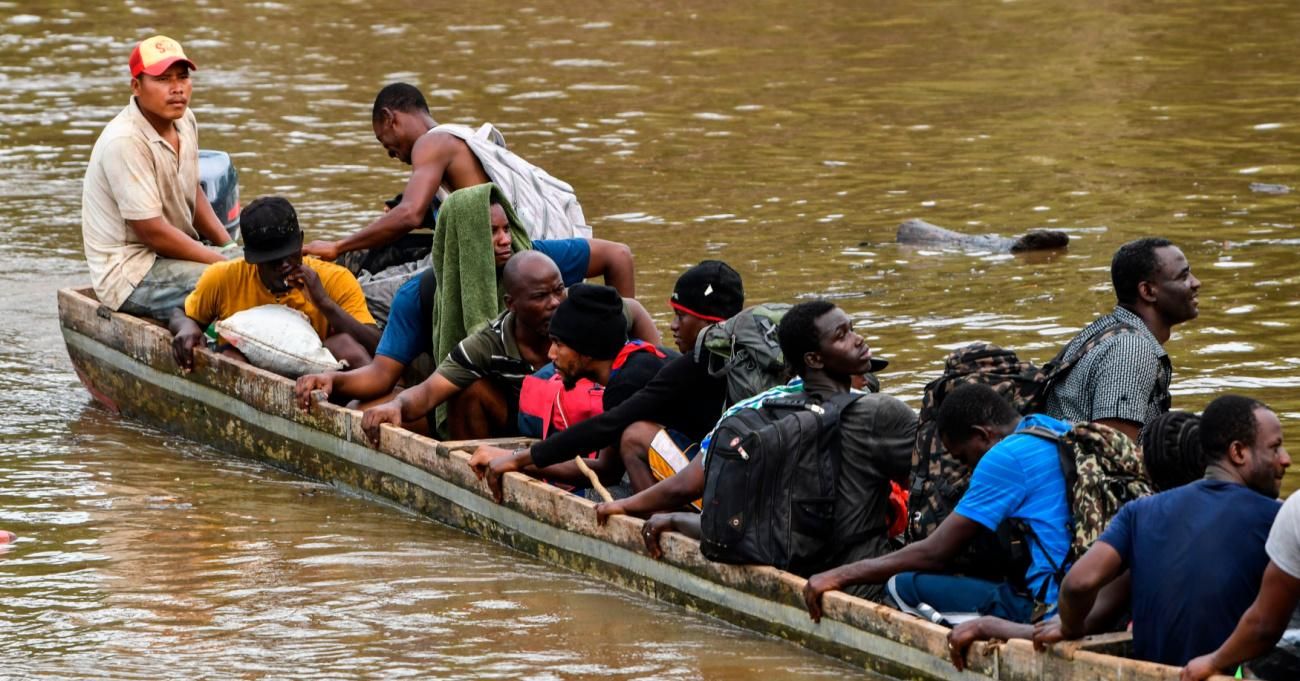 Haitain migrants cross a river into Panama on their way to the US