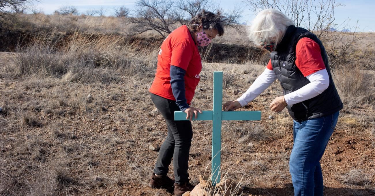 Two activists mark the place were a migrant's remains were found in the Arizona desert.