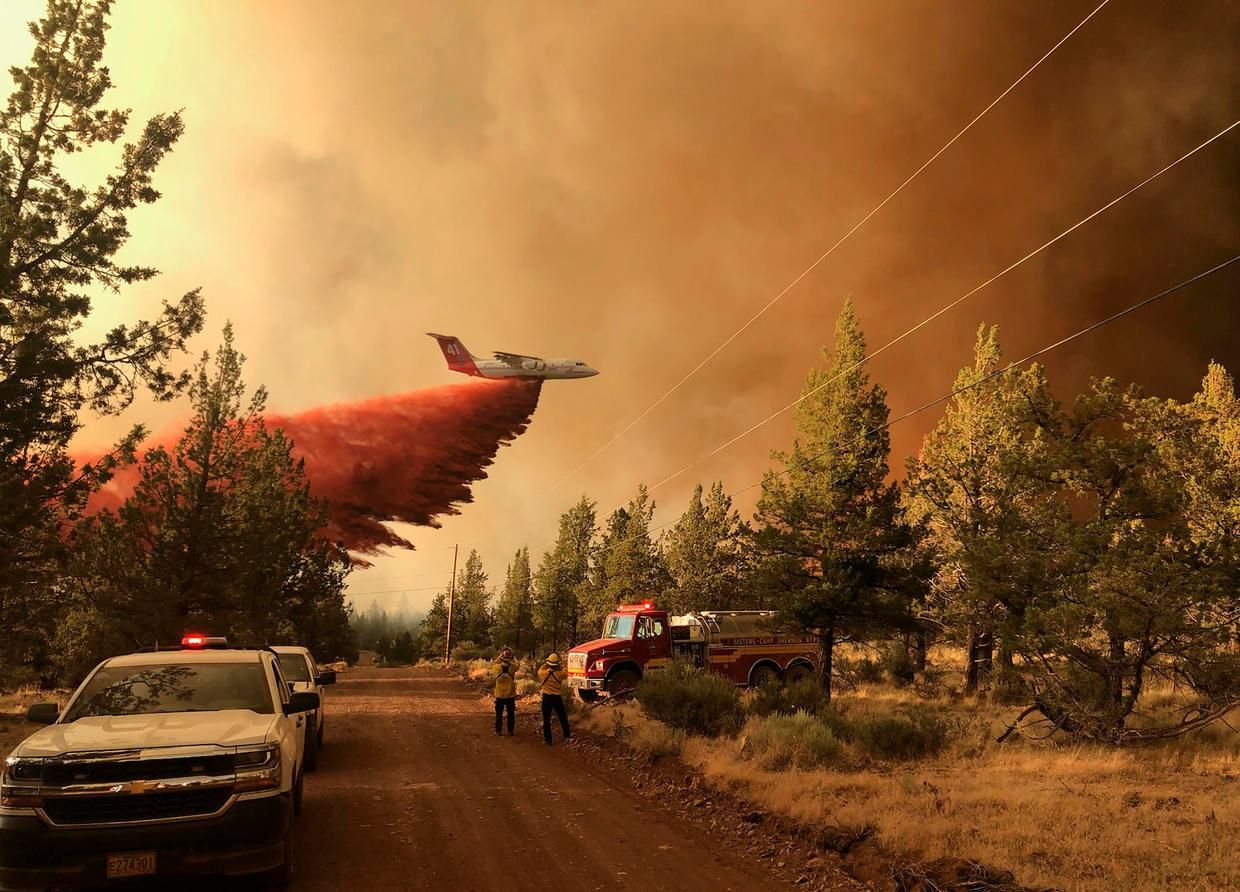 A firefighting tanker drops retardant over the Grandview Fire on July 11, 2021, northeast of Sisters, Oregon. (Photo: Oregon Department of Forestry via Getty Images)