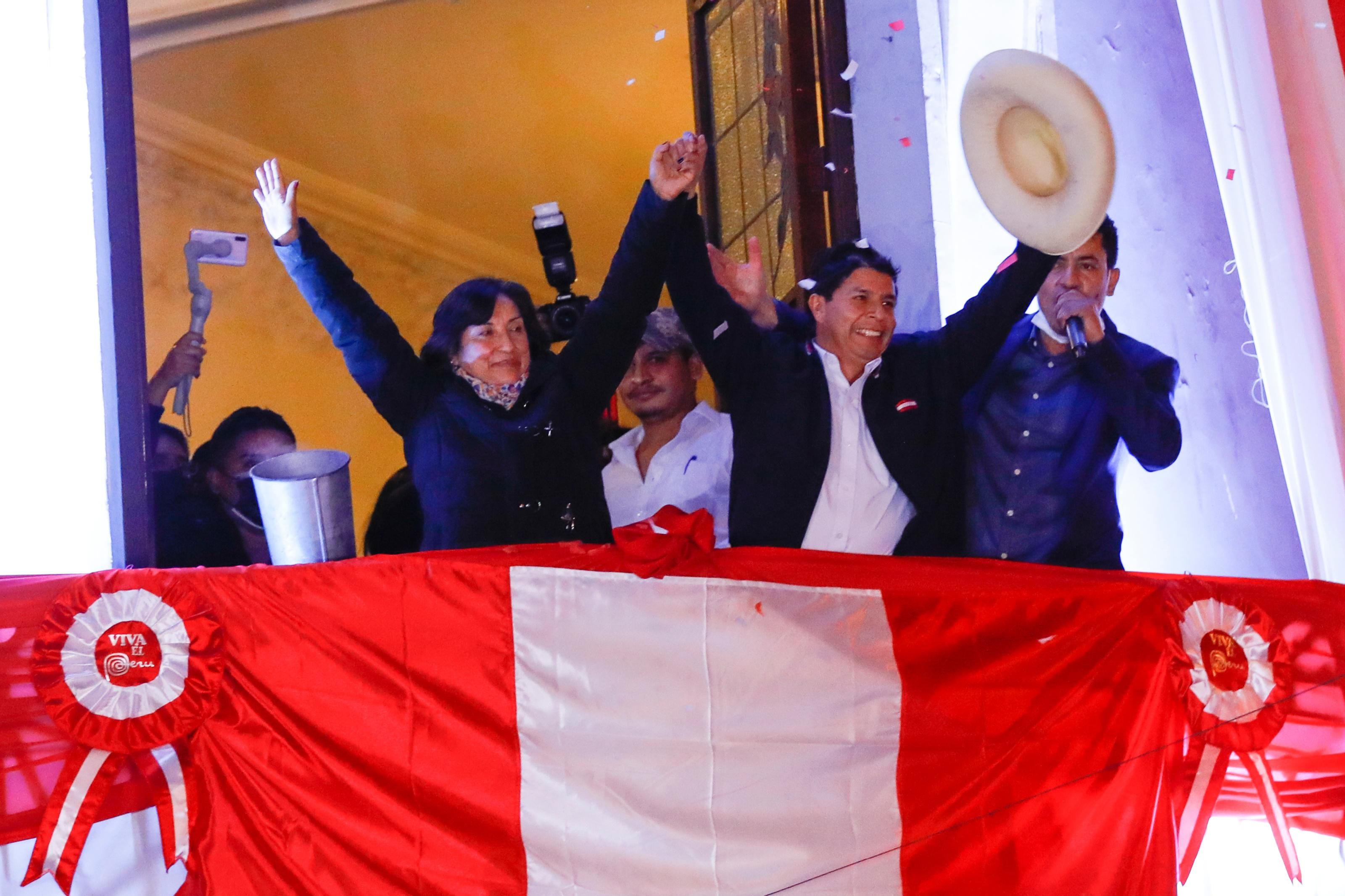 Pedro Castillo, the president-elect of Peru, and his running mate Dina Boluarte, wave to supporters during a celebration following the official announcement of their victory on July 19, 2021 in Lima, Peru. (Photo: Ricardo Moreira via Getty Images)