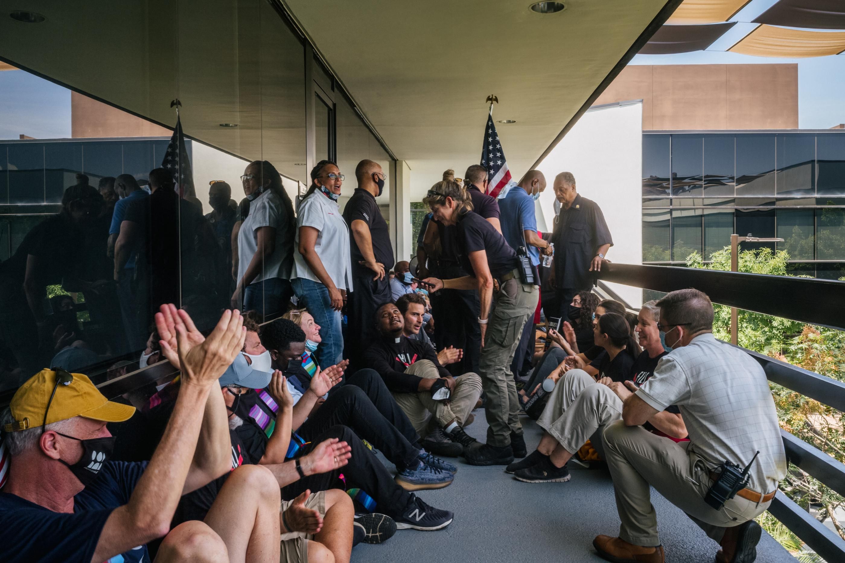 Protesters are processed by law enforcement during a sit-in demonstration outside the office of Sen. Kyrsten Sinema (D-Ariz.) on July 26, 2021 in Phoenix. (Photo: Brandon Bell via Getty Images)
