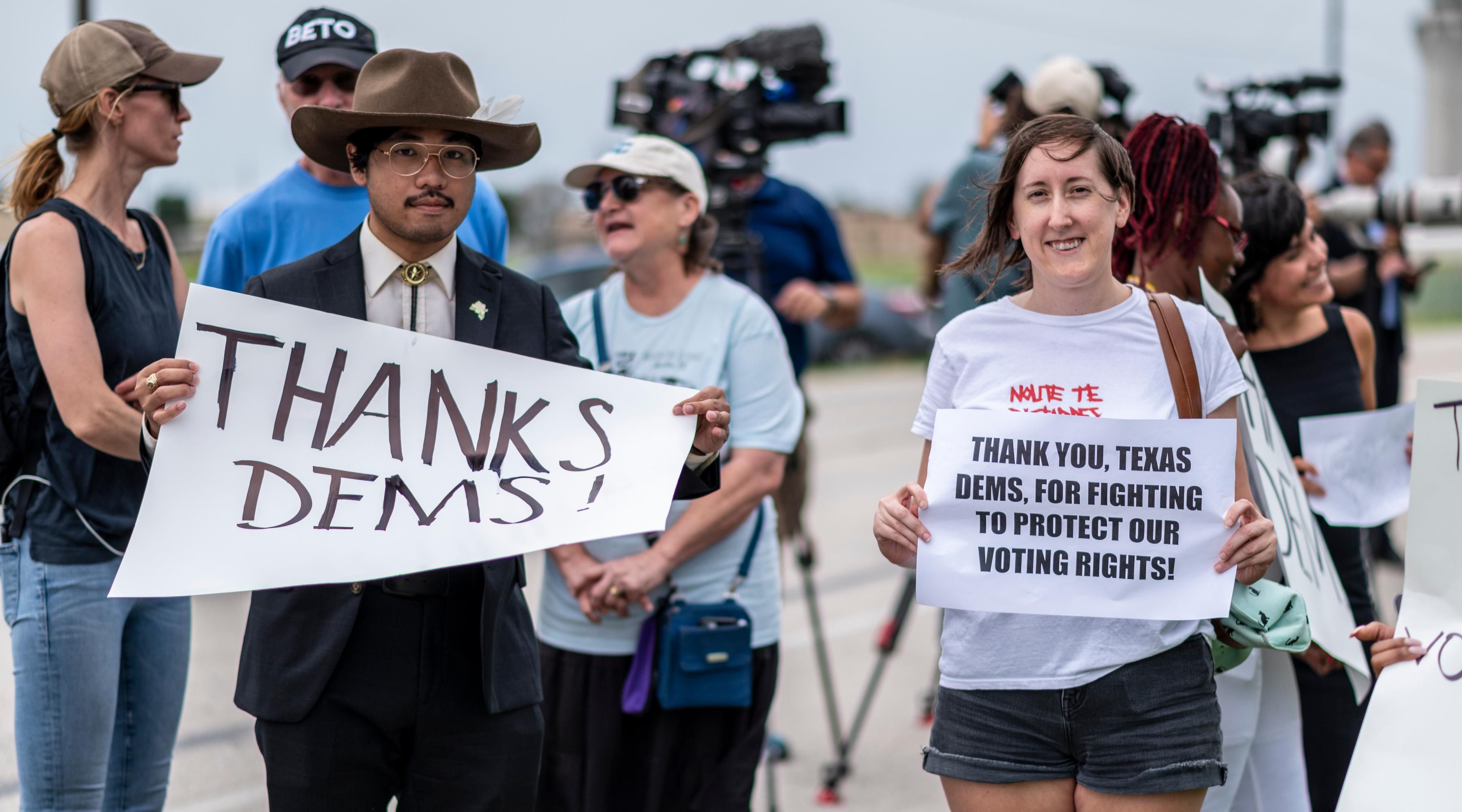 Supporters for Texas Democrats stand outside the Austin Bergstrom International Airport on July 12, 2021 in Austin, Texas. Texas Democrats fled the state to prevent a quorum after protesting SB7, a voting protection bill that Democrats have criticized as being too restrictive.